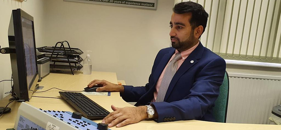 Dharmin at Desk 2.jpg