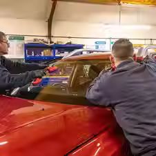 Workers installing car windshield