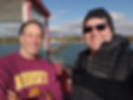 Owner of the Sturgeon Bay North Pierhead Lighthouse Jeff Feuerstein (Left) and Jake Heffernan stand on the lighthouse's gallery. The Sturgeon Bay Ship Canal Lighthouse can be seen in the background.