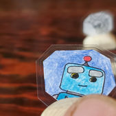 Collectable coin artwork featuring a cartoon Robot character and vivid colors.  The art sits on a hand crafted wooden base made from eucalyptus wood. Created by IW Comics .Shop