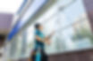 An employee of a professional cleaning service in overalls washes the facade and windows w