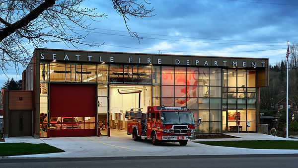 The exterior of Seattle Fire Station 30, a red brick building with two garage doors.