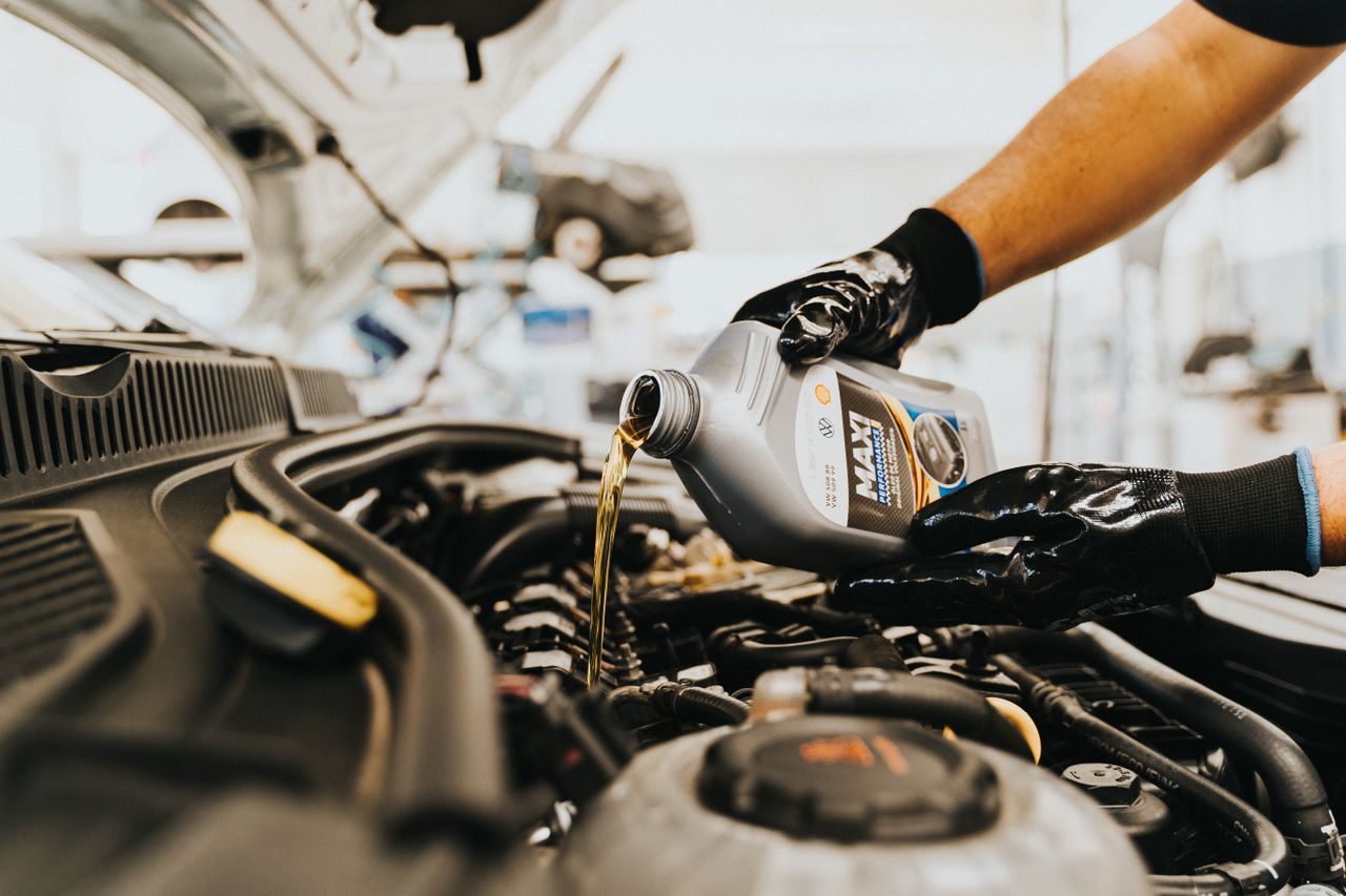Real motor oil being poured into an engine during service