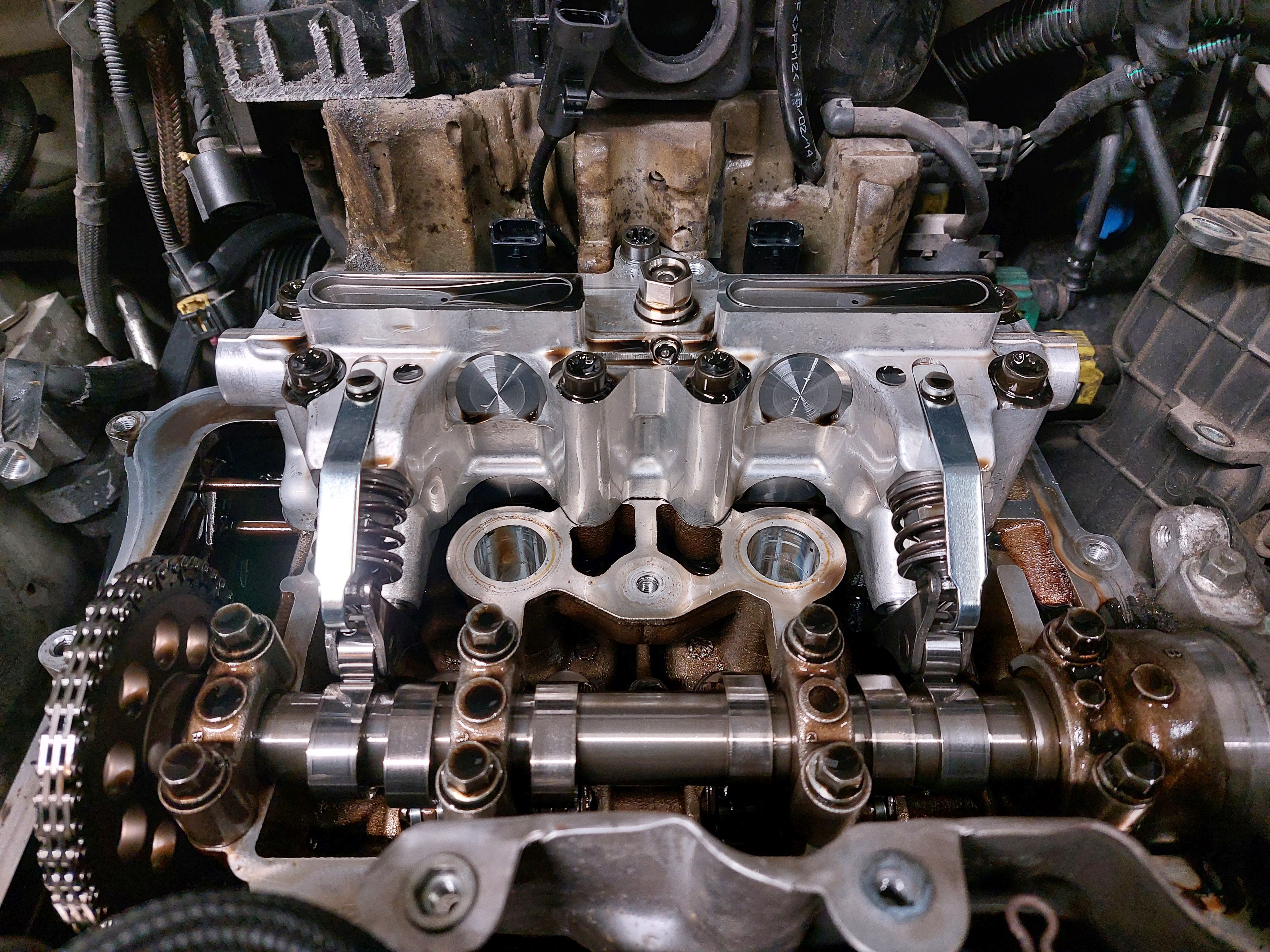 Real automobile camshaft and timing chain photographed with the cylinder head exposed