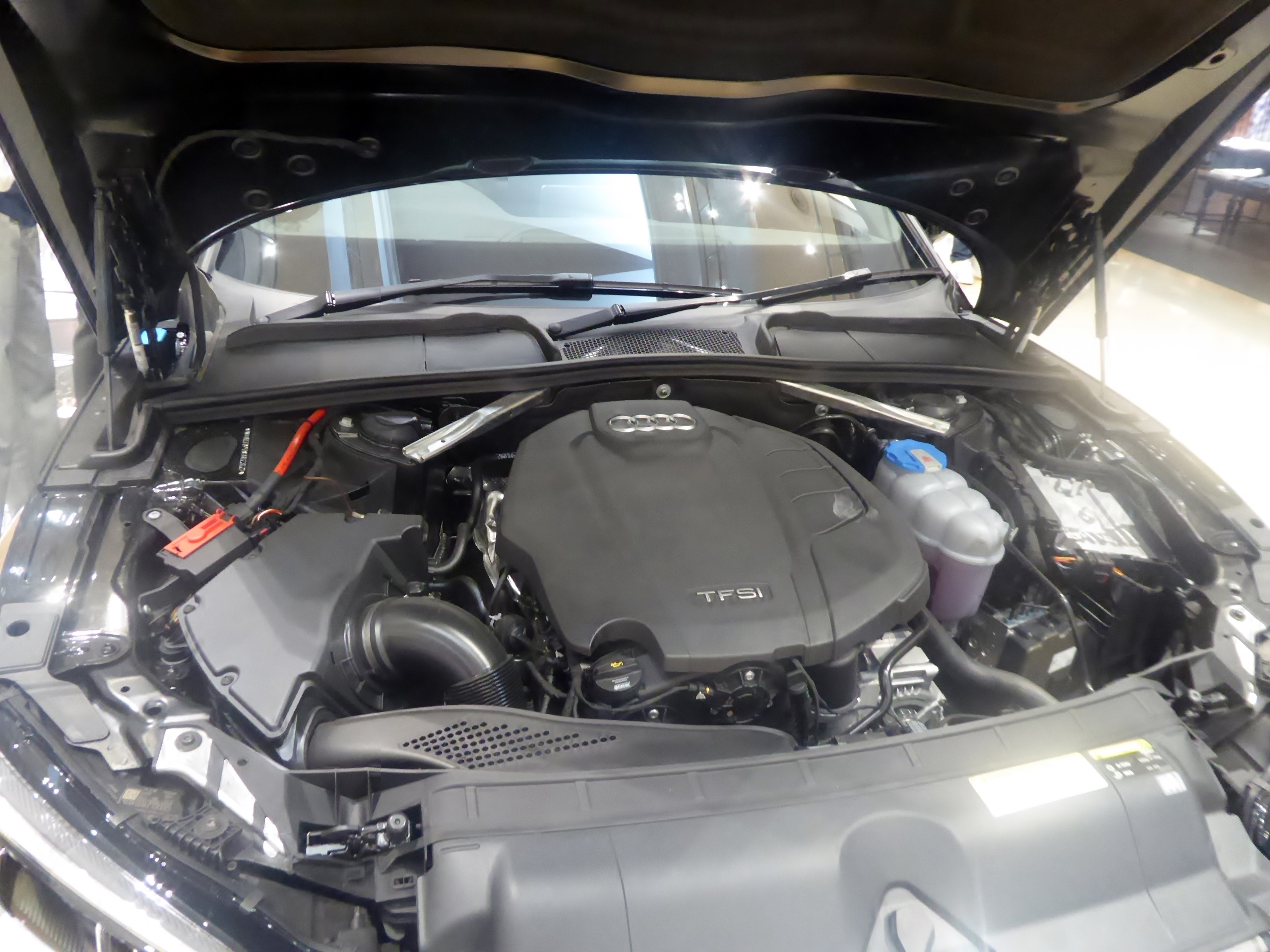 Genuine Audi A5 Sportback 45 TFSI quattro engine bay photographed in 2019 with Audi engine cover; engine designs vary by year