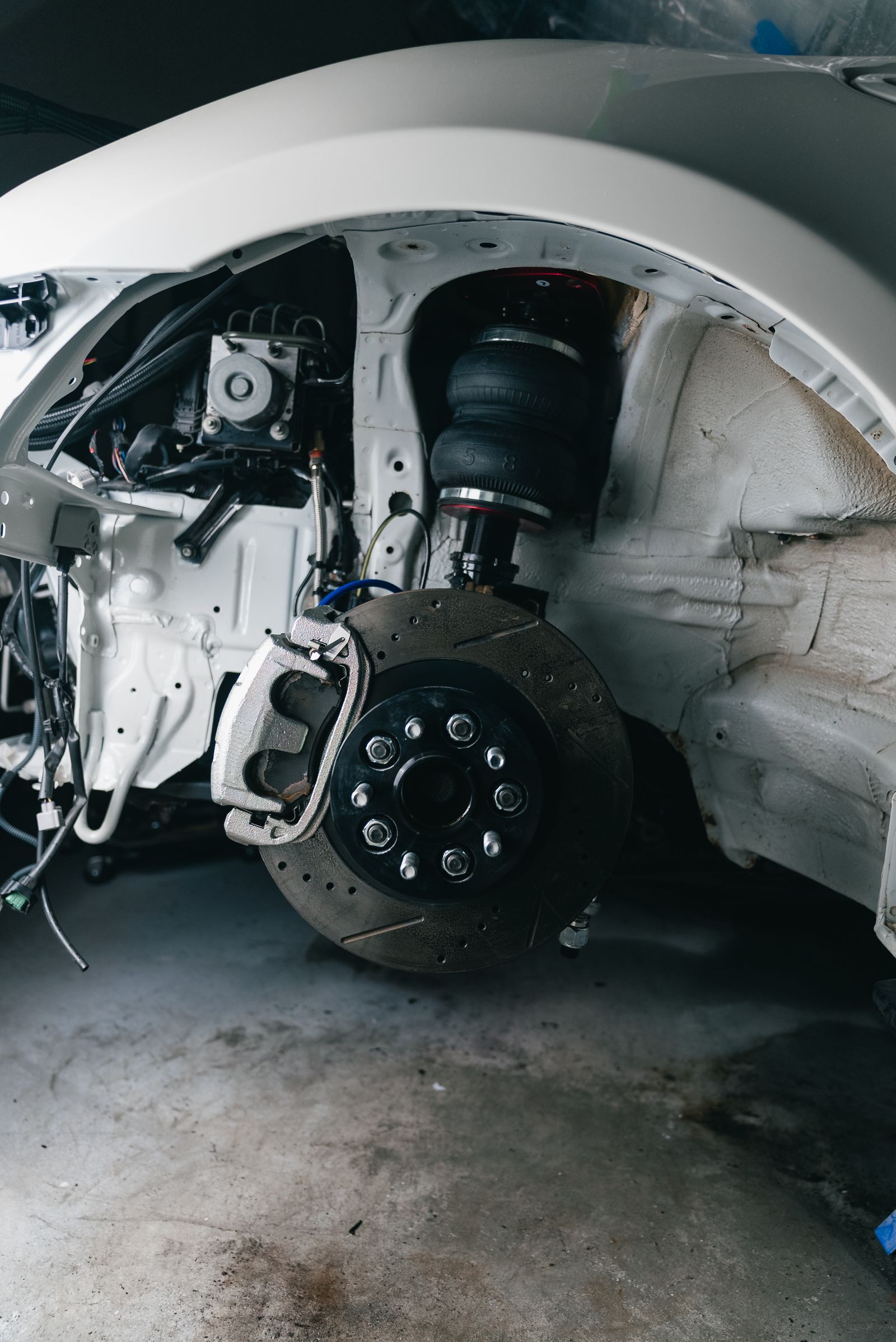Photographed suspension and brake assembly with suspension spring visible