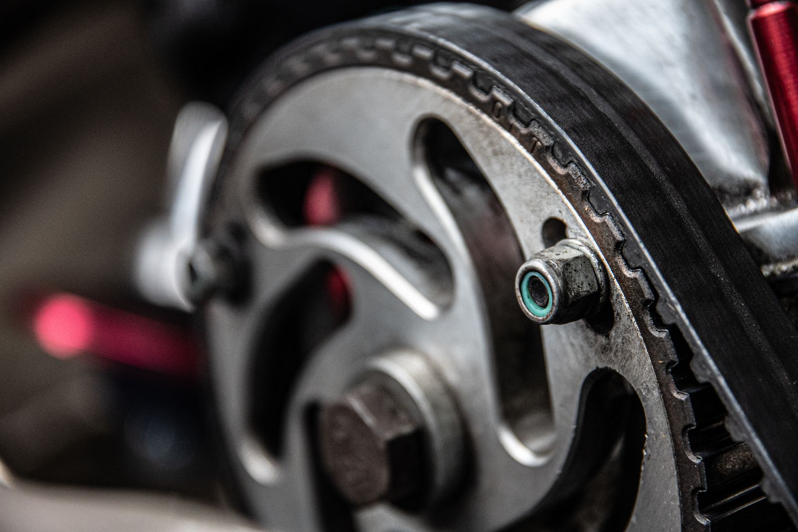 Real camshaft sprocket and toothed timing belt, close-up photograph