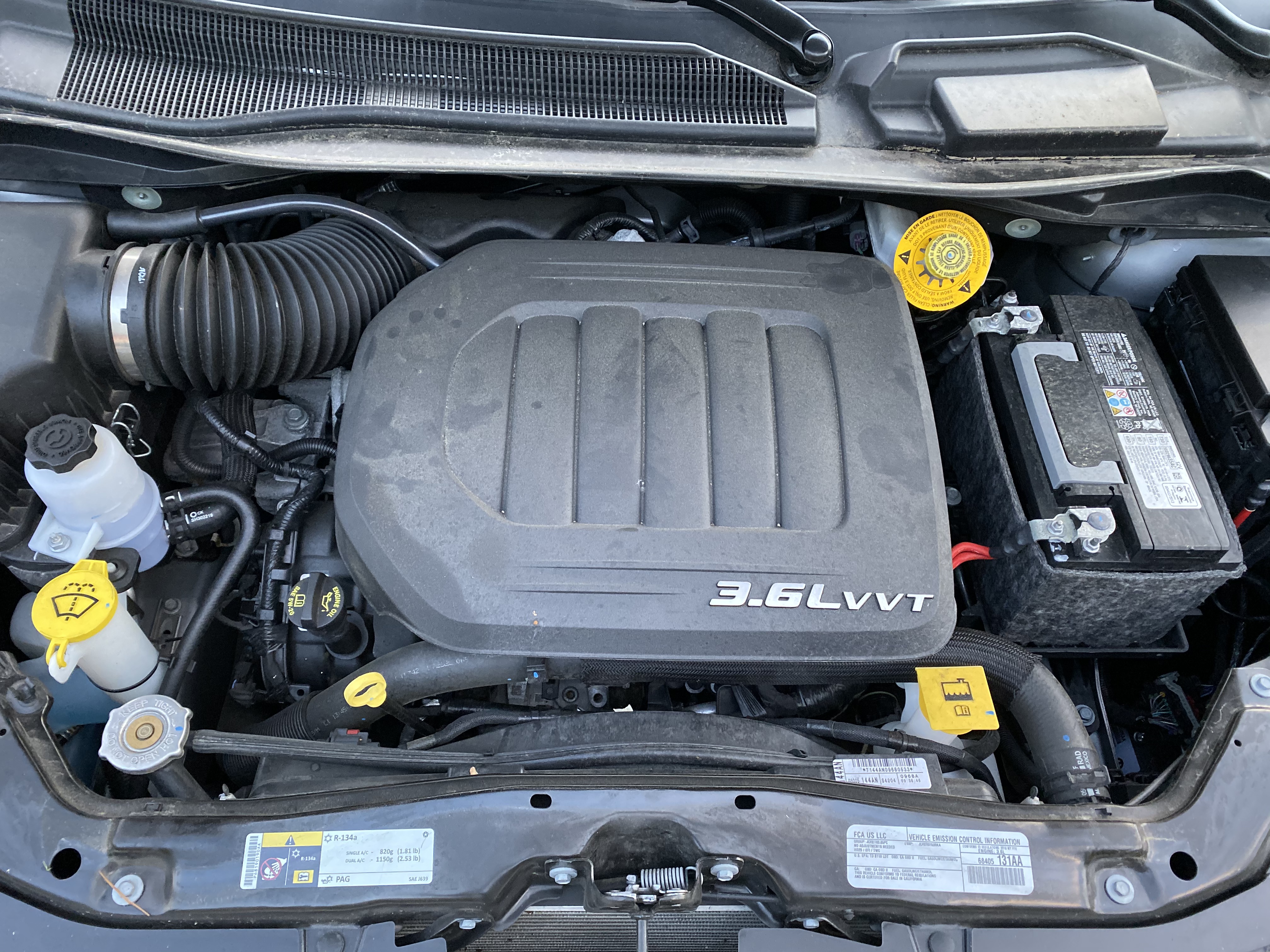 Photograph of a 3.6L Pentastar V6 engine bay in a 2018 Dodge Grand Caravan, not a shop repair