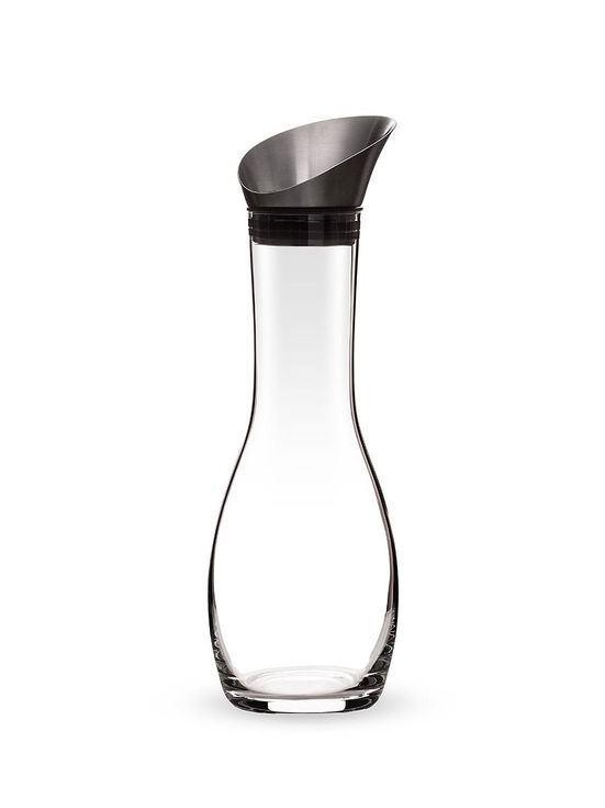 Empty glass carafe with metal top, stylish design, perfect for serving drinks.
