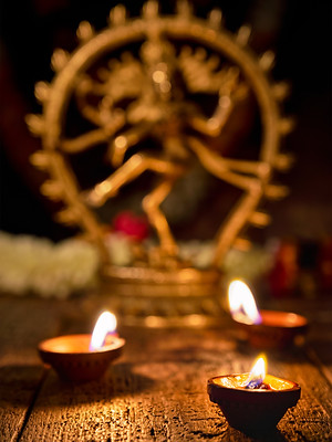 Maha Shivaratri or Diwali concept - Shiva Nataraja statuette with Diwali lights oil ghee c