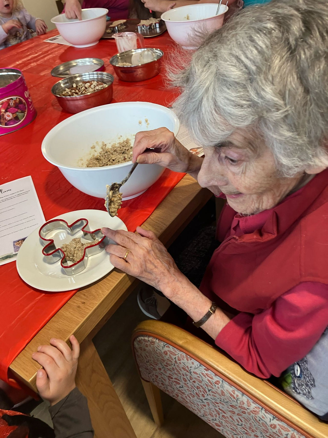 children, staff and residents making bird feeders