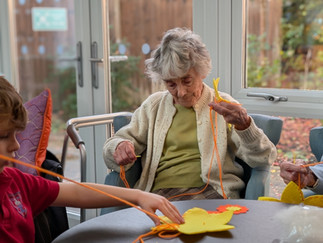 care home resident sewing daffodil cushions