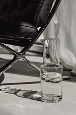 Pure water in a glass jug with a naturally shaped tumbler, simple modern design