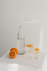 Healthy fresh oranges with water in glass and bottle, minimalist lifestyle inspiration