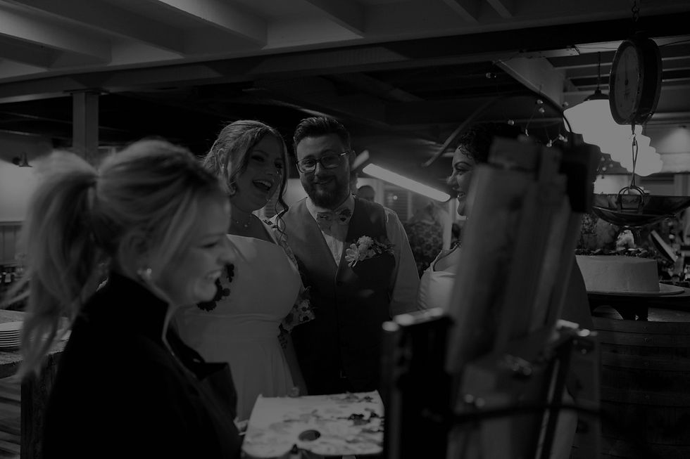 Live wedding painter Sydney shows couple their painting.