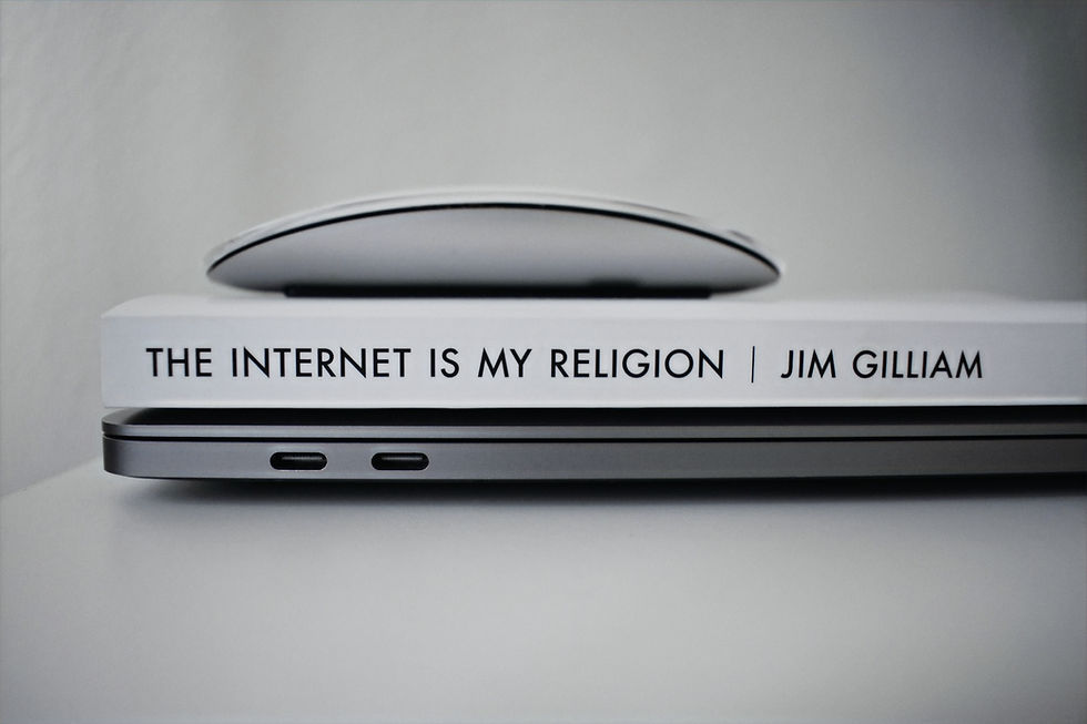 The spine of Jim Gillian's book "Internet is my religion", with an Apple Magic Mouse placed on it.