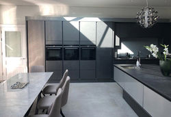 Tall full height fridge and freezer framing 3 x single ovens set in line for symmetry.