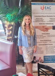 Courtney Chicvak attending a volunteer appreciation event for community mediators on Long Island. She stands before the Long Island Dispute Resolution Centers sign, expressing gratitude and recognition for their contributions to the community mediation program, creating a sense of camaraderie and celebration.