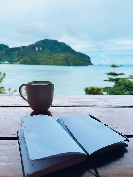 coffee and journal over water.jpg