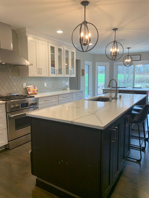 View of working island with sink and bar in breakfast nook