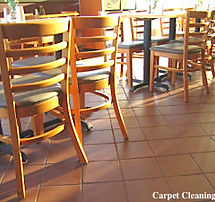 Restaurant with chairs, tables and a dirty tile flooring