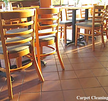 Restaurant with chairs, tables and a dirty tile flooring