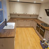 Modern kitchen with wooden floor and countertops before the restoration