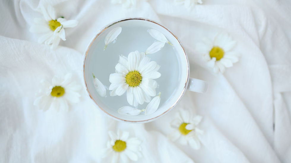 A ceramic cup of herbal chamomile tea resting on a wooden table next to dried flowers, symbolizing natural remedies and calm. (Photo by Melike  B on Pexels)