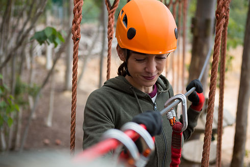 young-smiling-woman-holding-zip-line-cable-in-the-2021-08-28-16-47-21-utc.jpg
