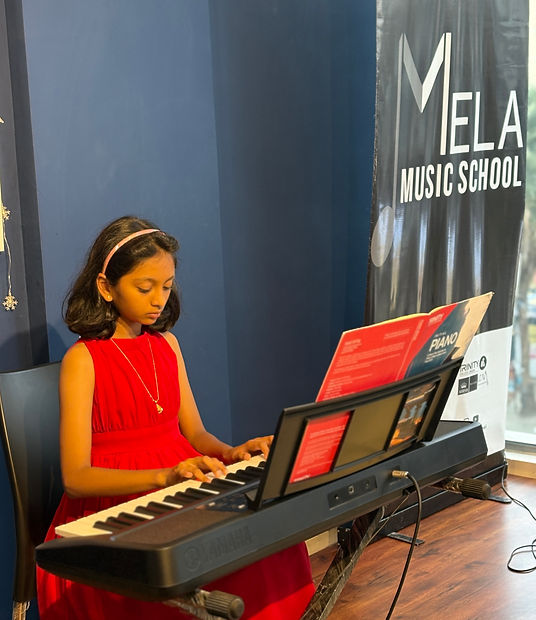 Student playing piano at Mela Music School in Thanisandra