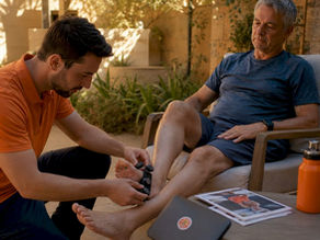 Physiotherapist fitting APOS therapy device on patient