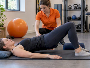 New mother doing guided postnatal Pilates