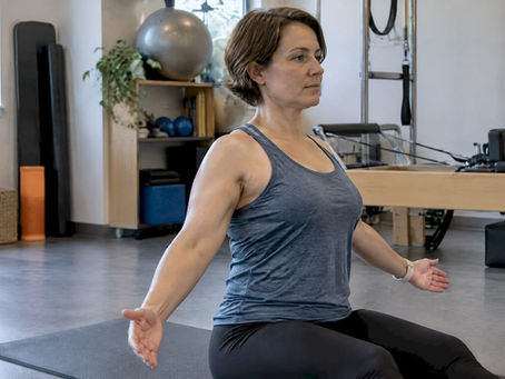 Woman performing Pilates shoulder rehabilitation exercise