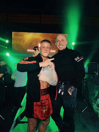 boxer at event with sling on arm and big smile