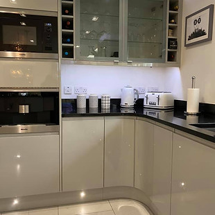 Illuminated work tops and cupboards in a kitchen