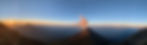 Volcan Agua in the background with Fuego erupting just after sunrise. Black smoke rising from the peak