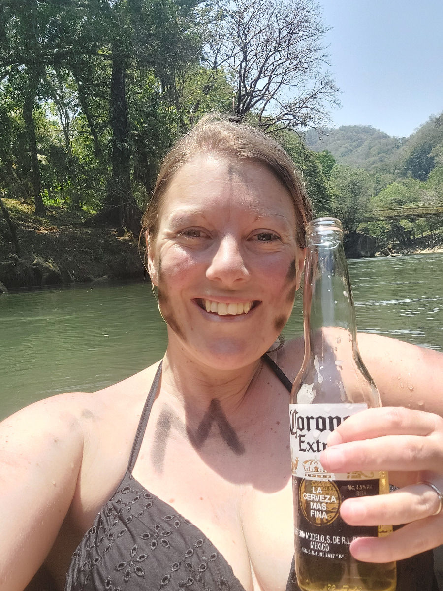 Tubing on Rio Cahabon, Becca enjoying a cold Corona whilst floating down stream