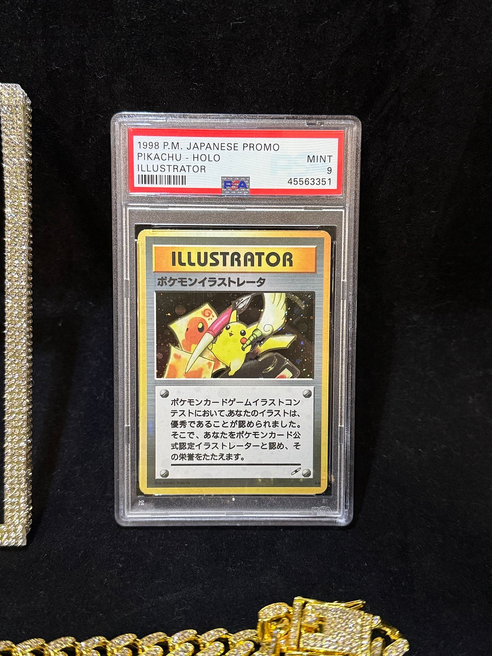 Thumbnail: Front view of Pikachu Illustrator replica card in PSA graded display case