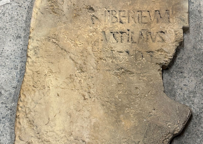 Museum-quality replica of the Pilate Stone featuring engraved Latin text and realistic aged stone texture.