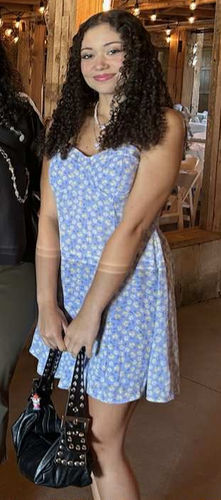 Hailey Buzbee standing blue dress