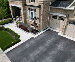 Horvath Landscaping front yard hardscape detail with modern pavers, edged planting beds, and a clean transition to the driveway.