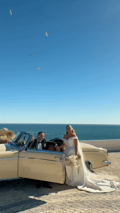 Bride and groom laughing together with ocean backdrop in Portugal