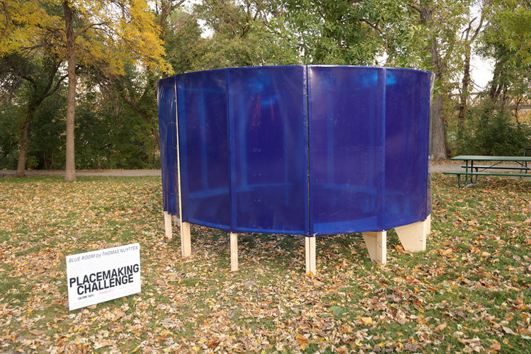 Placemaking challenge art installation: "Blue Room" comprised of transparent blue panels in a cylinder