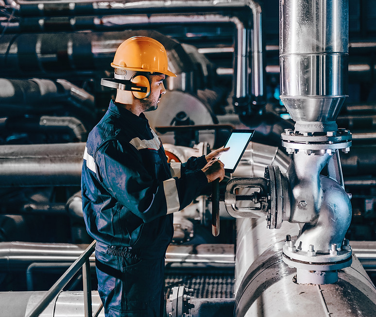 portrait-young-caucasian-man-dressed-work-wear-using-tablet-while-standing-heating-plant.j