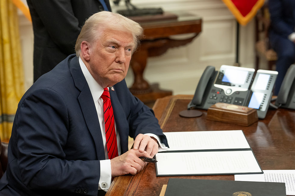 President Donald Trump signs executive orders in the Oval Office, Feb. 10, 2025