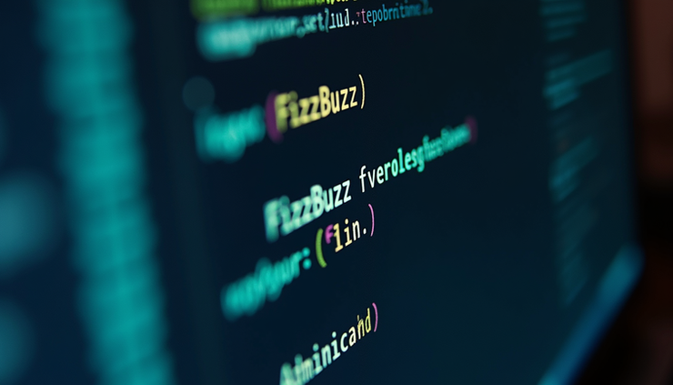 Eye-level view of a computer screen showing code editor with FizzBuzz program