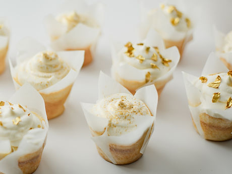 Cupcakes with white frosting and gold flakes, The Love Batch LLC
