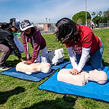 youth being taught CPR at a family health day