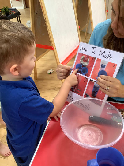 Toddler learning how to make playdough