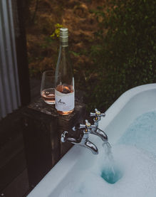 A glass of Ara Wines Rosé next to the bottle